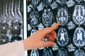 Person in White Long Sleeve Shirt Holding Black and White Round Wall Decor