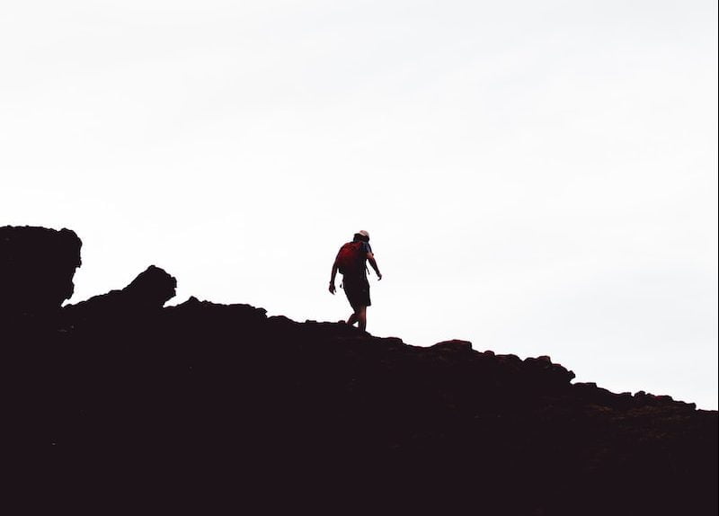 silhouette of man on hill