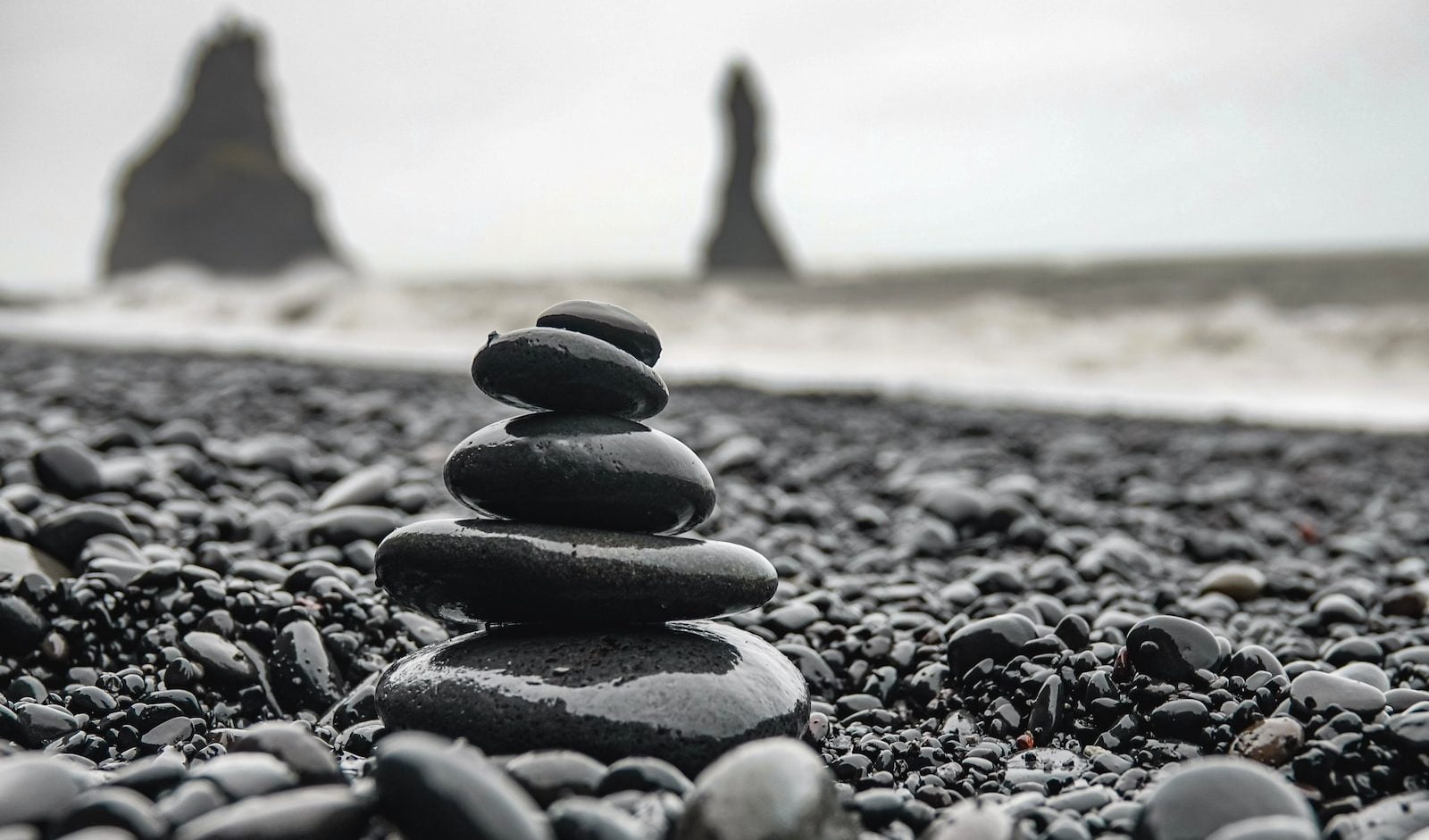 black stones on brown sand during daytime